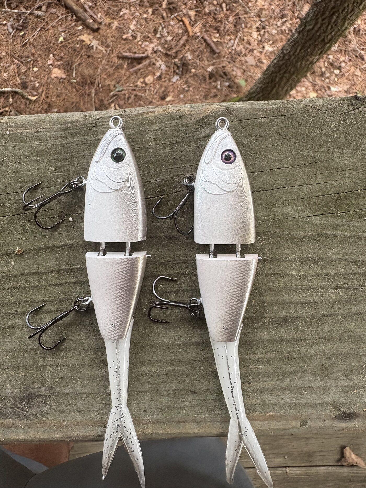 Two Cabretta Kidds in White pearl, rigged and ready, on a wooden bench